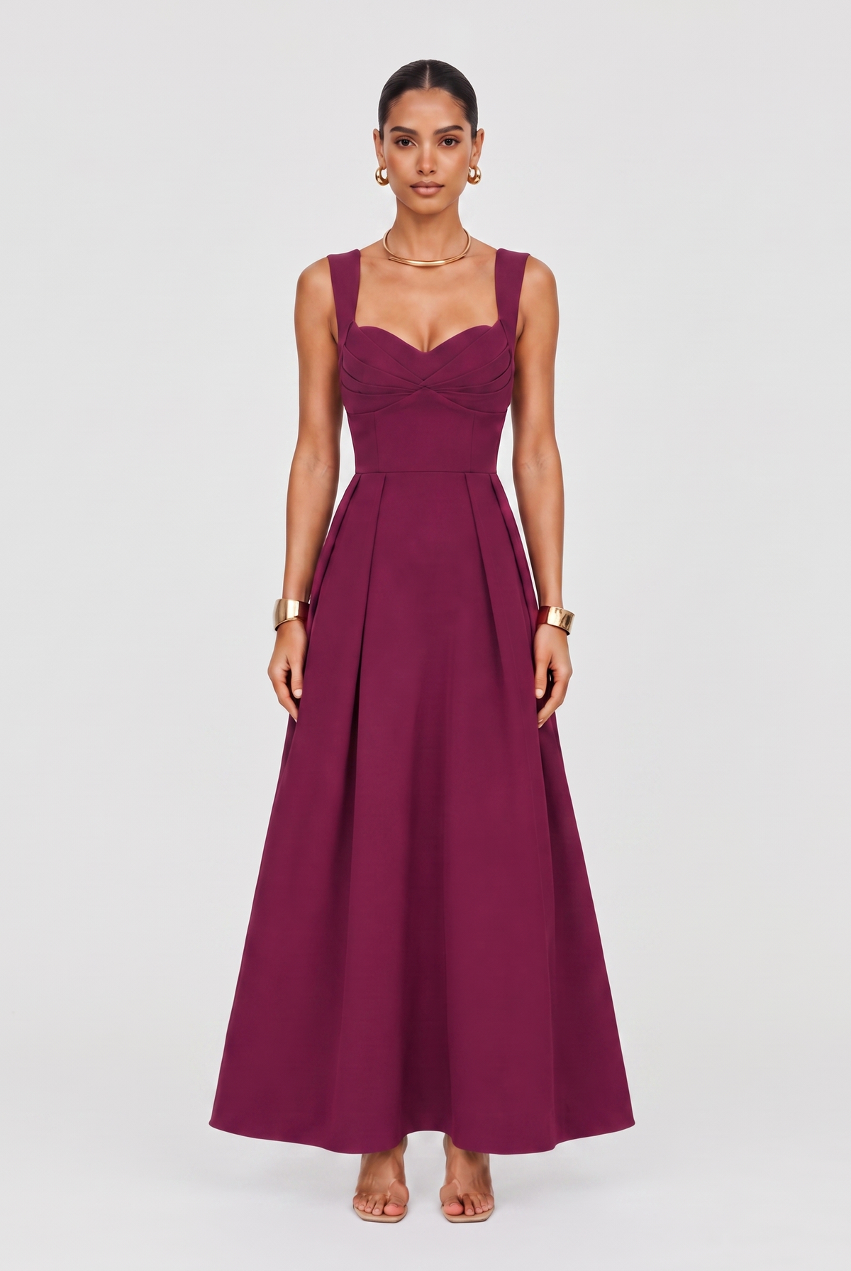 Woman wearing a wine-coloured formal maxi dress with sweetheart neckline, styled for a black-tie event